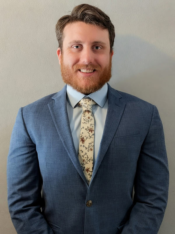 Will Cox, Jr., in a light blue suit